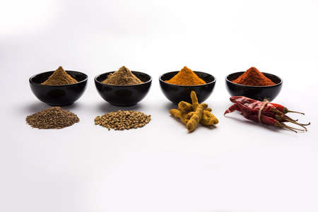 Indian colourful spices. Group photo of four basic Indian spices like raw red chilli, turmeric,...