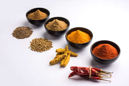 Indian colourful spices. Group photo of four basic Indian spices like raw red chilli, turmeric,...