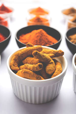 Indian colourful spices. Group photo of four basic Indian spices like raw red chilli, turmeric,...