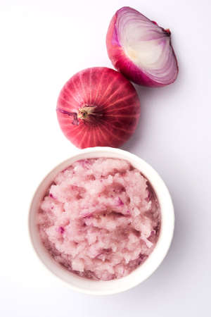 Onion Sauce or paste, in white or black ceramic bowl with raw cut onions, isolated over white background. Selective focusの写真素材
