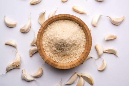 Garlic powder is ground, dehydrated garlic. It's a common seasoning  for pasta, pizza and grilled chicken.の写真素材