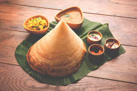 Indian Mother daughter sisters shopping with colourful bags, standing isolated over white backgroundの写真素材