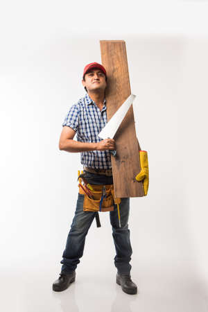 Handsome Indian Carpenter or wood worker in action, isolated over white backgroundの写真素材