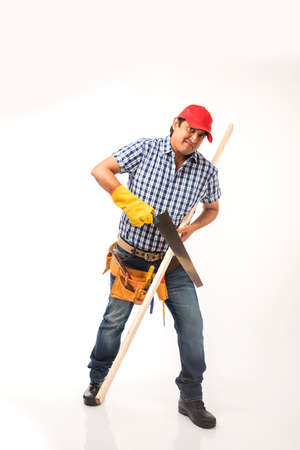 Handsome Indian Carpenter or wood worker in action, isolated over white background