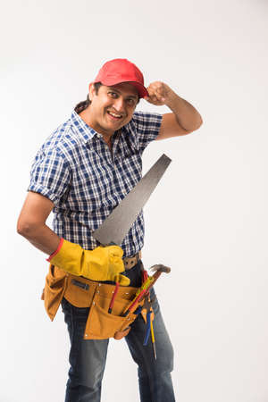Handsome Indian Carpenter or wood worker in action, isolated over white backgroundの写真素材