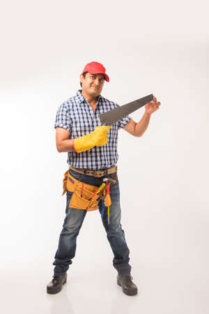 Handsome Indian Carpenter or wood worker in action, isolated over white backgroundの写真素材
