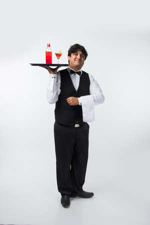 Asian Indian waiter or Bartender isolated over white background, selective focusの写真素材