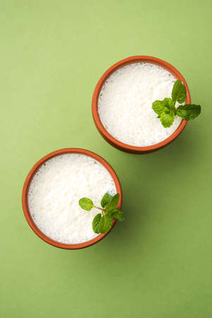 Lassie or lassi in terracotta glass - Lassi is an Authentic Indian cold drink made up of curd and milk and sugar, selective focusの写真素材