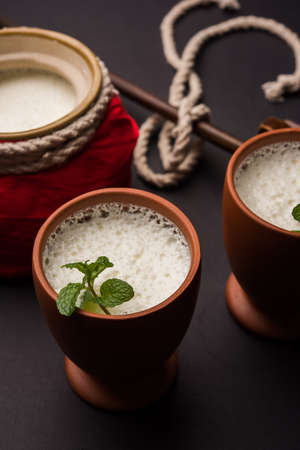 Lassie or lassi in terracotta glass - Lassi is an Authentic Indian cold drink made up of curd and milk and sugar, selective focusの写真素材