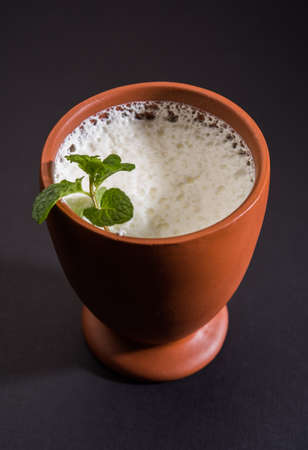 Lassie or lassi in terracotta glass - Lassi is an Authentic Indian cold drink made up of curd and milk and sugar, selective focusの写真素材