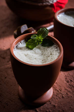 Lassie or lassi in terracotta glass - Lassi is an Authentic Indian cold drink made up of curd and milk and sugar, selective focusの写真素材