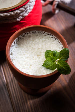 Lassie or lassi in terracotta glass - Lassi is an Authentic Indian cold drink made up of curd and...