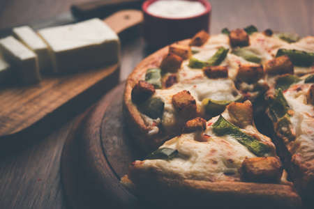 Indian Paneer Pizza with fresh cottage Cheese cubes and white sauceの写真素材