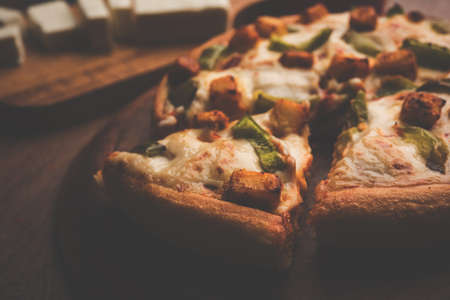 Indian Paneer Pizza with fresh cottage Cheese cubes and white sauceの写真素材