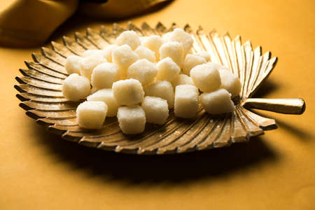 Bengali Sweet Chena Murki served in a golden plate, selective focusの写真素材