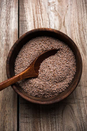 Psyllium husk or isabgol which is fiber derived from the seeds of Plantago ovata, mainly found in India. Served in a bowl over moody background. selective focusの写真素材