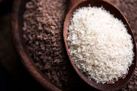 Psyllium husk or isabgol which is fiber derived from the seeds of Plantago ovata, mainly found in India. Served in a bowl over moody background. selective focusの写真素材