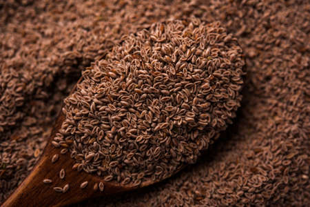 Psyllium husk or isabgol which is fiber derived from the seeds of Plantago ovata, mainly found in India. Served in a bowl over moody background. selective focusの写真素材