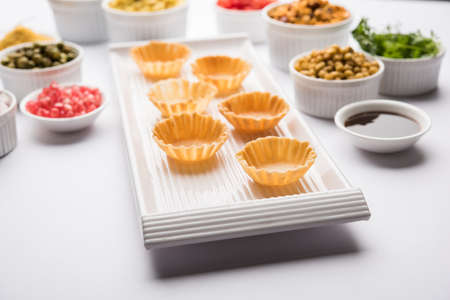 empty Crispy Canape or canapÃ© is a starter recipe from India - Round or square shaped Puri to be Filled with Yogurt and potato , chat, sev, tamarind sauce etc. selective focusの写真素材