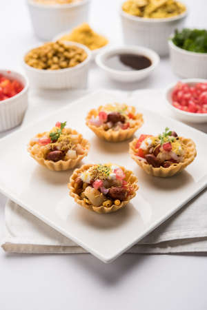 Crispy Canape or canapÃ© is a starter recipe from India - Round or square shaped Puri Filled with Yogurt and potato , chat, sev, tamarind sauce etc. selective focusの写真素材