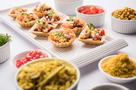 Crispy Canape or canapÃ© is a starter recipe from India - Round or square shaped Puri Filled with Yogurt and potato , chat, sev, tamarind sauce etc. selective focusの写真素材