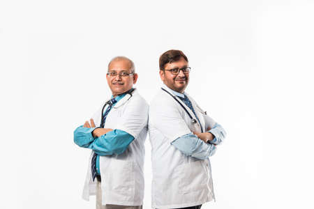 Two Indian/asian male doctors discussing medical case with chart, standing isolated over white backgroundの写真素材