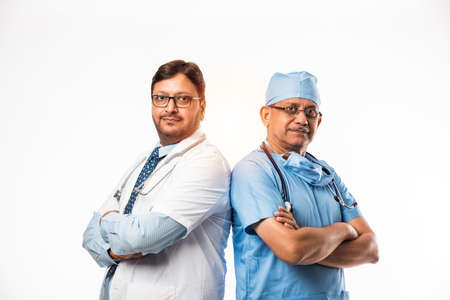 Indian/asian male surgeon and doctor/ medical practitioner standing together, isolated over white backgroundの写真素材