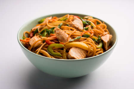 Chicken Hakka/Schezwan noodles served in a bowl with chopsticks. selective focusの写真素材