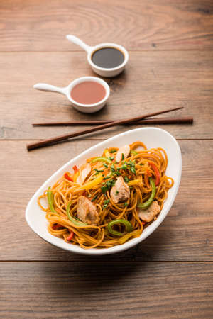 Chicken Hakka/Schezwan noodles served in a bowl with chopsticks. selective focusの写真素材