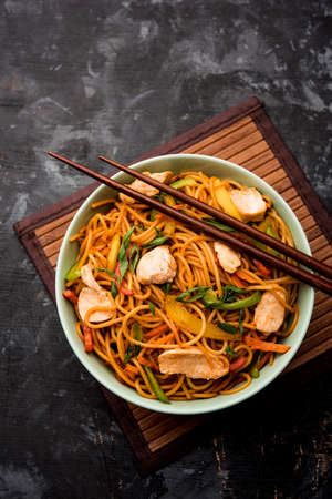 Chicken Hakka/Schezwan noodles served in a bowl with chopsticks. selective focusの写真素材