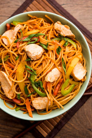 Chicken Hakka/Schezwan noodles served in a bowl with chopsticks. selective focusの写真素材