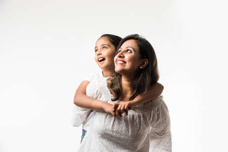 Indian mother daughter on white background hugging, kissing, riding, flying, pointing, presenting...