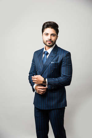 Portrait of Indian Male businessman standing over black backgroundの写真素材