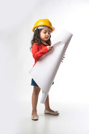 Small Indian girl engineer with yellow hard Hat and Drawing paper roll or plan, isolated over white...