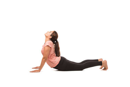 Indian Woman / Girl performing Yoga asana or meditation or dhyan, sitting isolated over white...