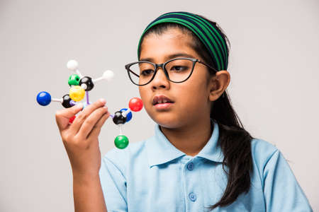 Indian Female student Using Molecular Model Kit for studying Science, selective focusの写真素材