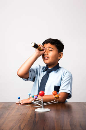 Boy studying Planets or planetary science with 3d Model of our solar system