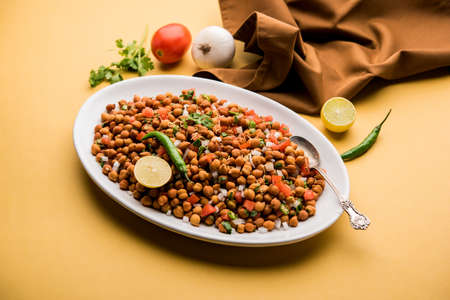 Black Chickpea Chaat or Kala Chana Chat recipe is a popular snack recipe from India, served in a...