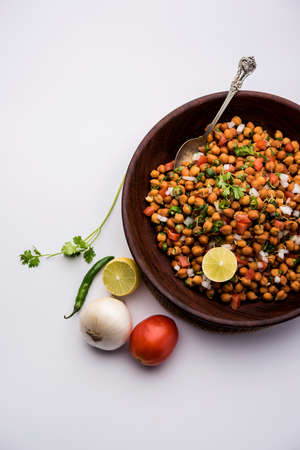 Black Chickpea Chaat or Kala Chana Chat recipe is a popular snack recipe from India, served in a...