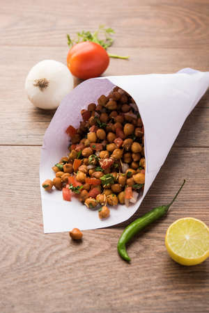 Black Chickpea Chaat or Kala Chana Chat recipe is a popular snack recipe from India, served in a...