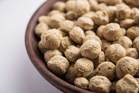Raw Soya Chunks, Soy Meat for vegans isolated on white background in a bowl or in heap form