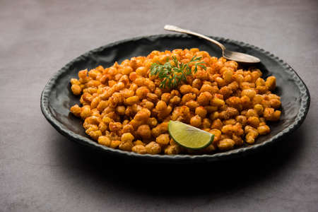 Crispy Fried Corn is a Chatpata starter snack from India, served in a bowl, selective focusの写真素材