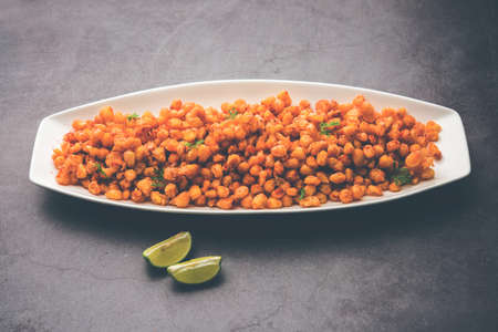 Crispy Fried Corn is a Chatpata starter snack from India, served in a bowl, selective focus