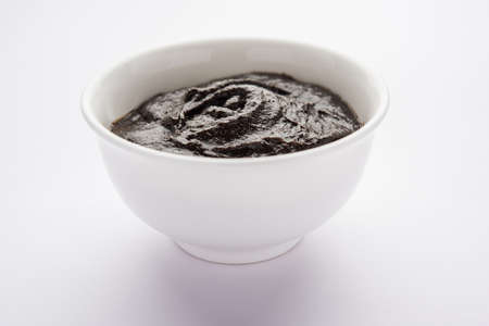 Chyawanprash or Chyavanprash is an Indian Ayurvedic Immunity booster health supplement made up of a concentrated blend of minerals and nutrient-rich herbs, served in a bowl, isolatedの写真素材