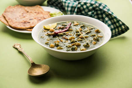chickpea Spinach Curry or Chana Masala with Palak served with Rice and flatbread or Paratha, selective focusの写真素材
