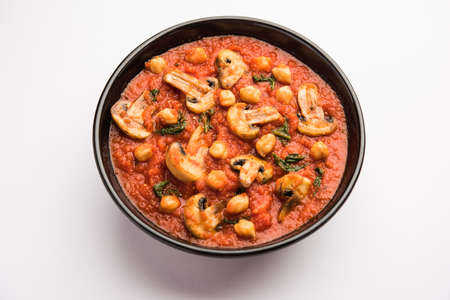 Mushroom sabzi in tomato curry with chickpea and spinach, Indian main course menu served with Paratha and cooked white riceの写真素材