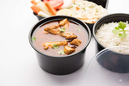 Indian Red Chicken curry packed for home delivery in plastic container