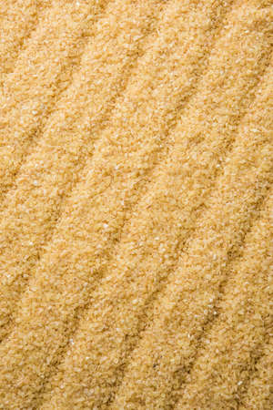 Gehu Dalia or Daliya also known as Cracked or Broken Wheat, served in a bowl or spoon, healthy Indian foodの写真素材