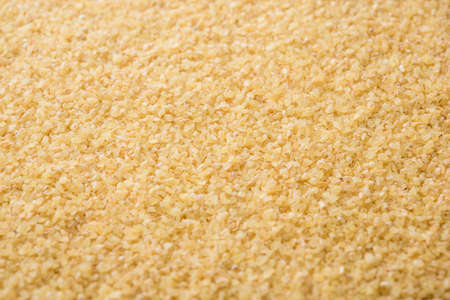 Gehu Dalia or Daliya also known as Cracked or Broken Wheat, served in a bowl or spoon, healthy Indian foodの写真素材