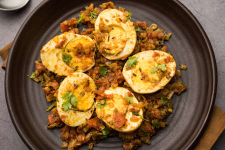 Masala Egg Tawa Fry or ande ki sabzi, served in a plate. selective focusの写真素材